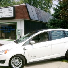 Electric car CMax plugged into the sun