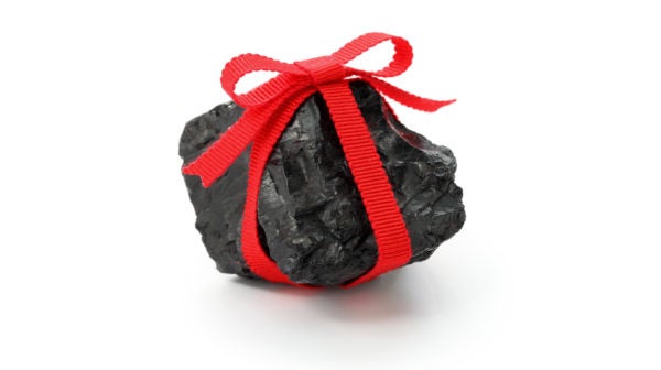 A lump of coal wrapped in a red ribbon
