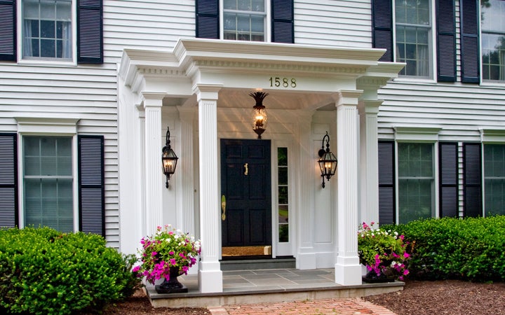 A portico covering a porch on a residential home