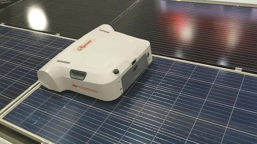 A Radiant solar panel cleaning robot on top of a solar panel.