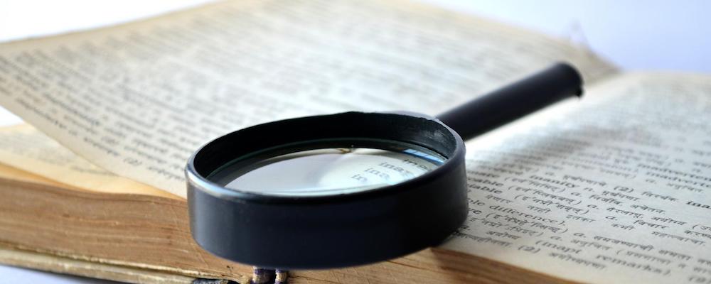 Magnifying glass resting on an open book