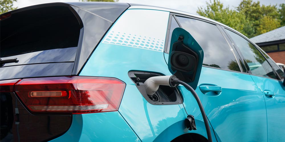 a blue electric car charging