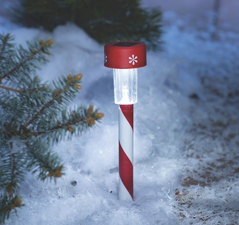 crimson and white solar-powered yard stake in the snow