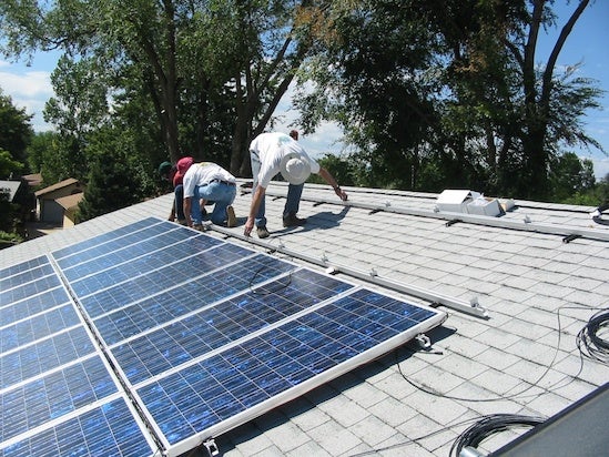 Installing solar power. Courtesy NREL